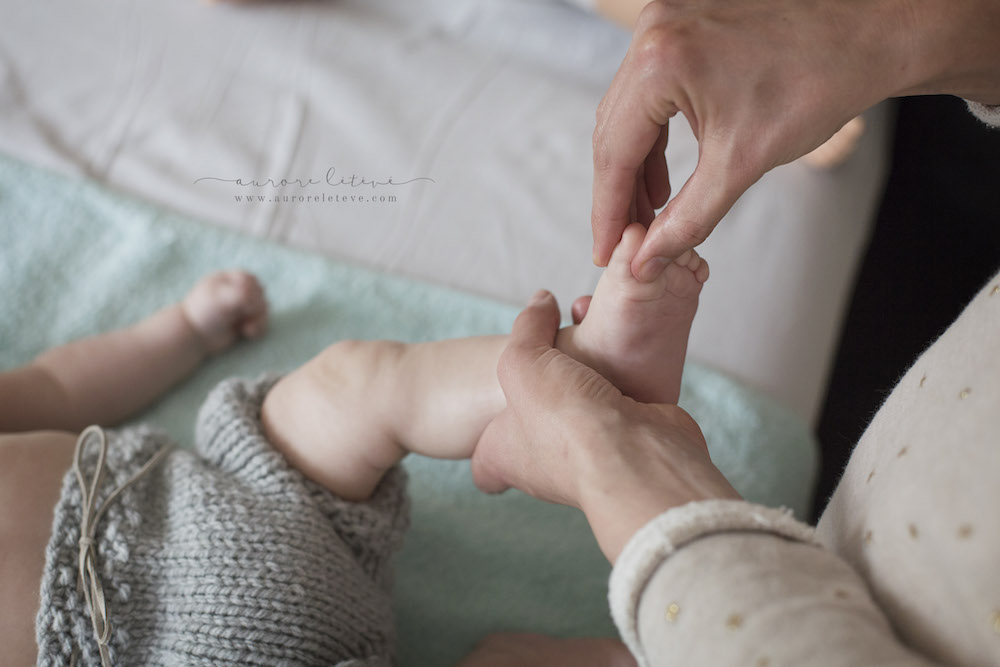 Maman massant son bébé pendant un atelier massage bébé à Villeurbanne